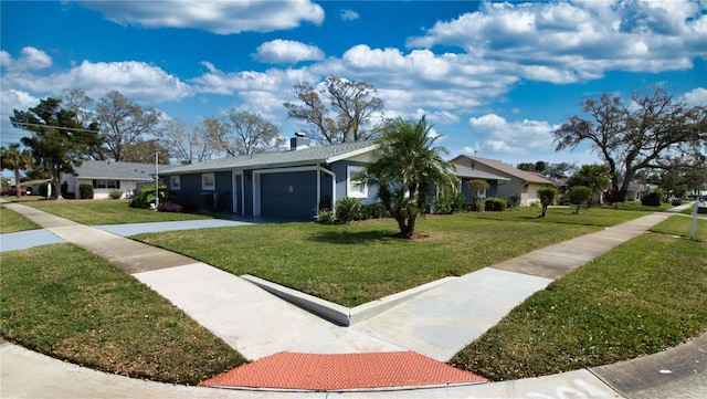 ranch-style home with a front lawn, a garage, and a chimney