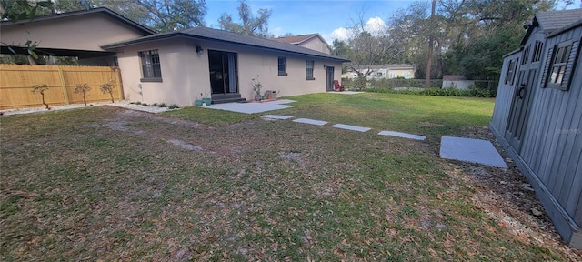 view of yard featuring entry steps and a fenced backyard