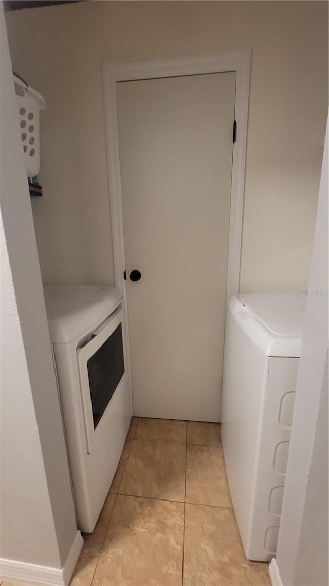 washroom featuring laundry area and light tile patterned flooring