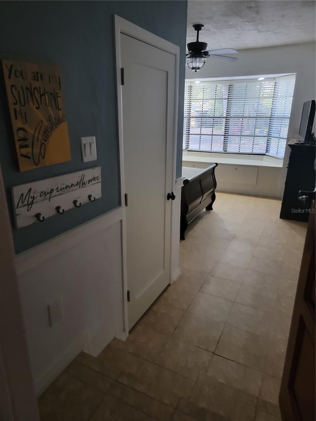 hallway with a textured ceiling