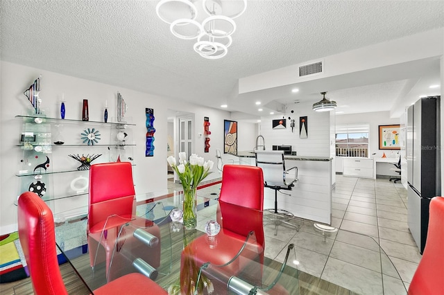 dining area featuring light tile patterned floors, visible vents, a textured ceiling, and recessed lighting