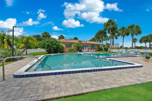 pool featuring a patio area and fence