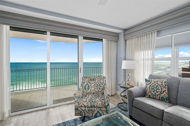 living area with a water view and wood finished floors