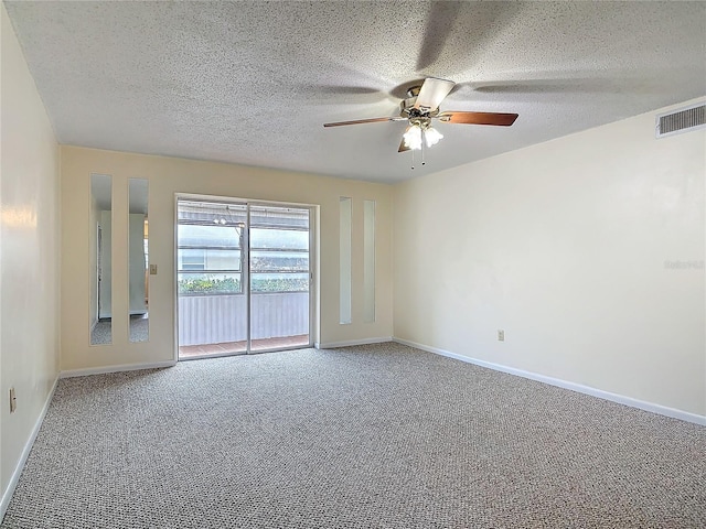 carpeted empty room with ceiling fan, visible vents, and baseboards