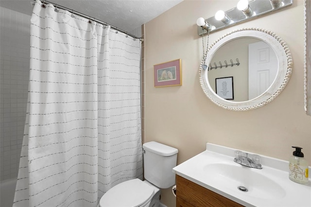 bathroom featuring toilet, a textured ceiling, and vanity