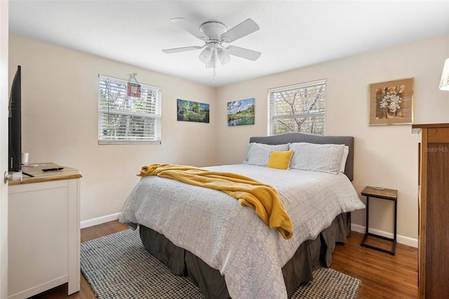 bedroom featuring ceiling fan, wood finished floors, and baseboards