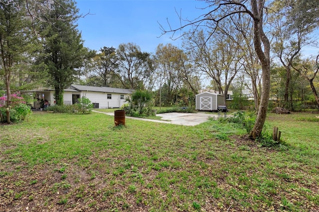 view of yard with a storage shed, driveway, and an outdoor structure