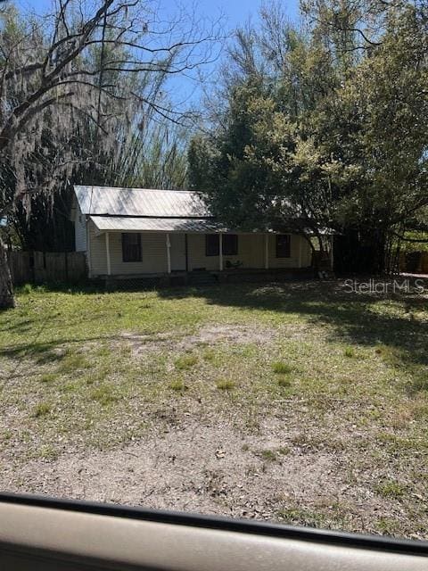 view of yard featuring driveway and fence