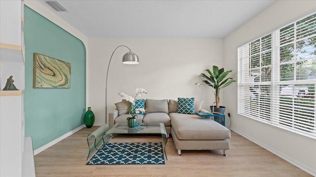 sitting room featuring visible vents, baseboards, and wood finished floors