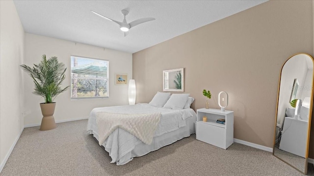 bedroom featuring baseboards, light colored carpet, ceiling fan, and a textured ceiling