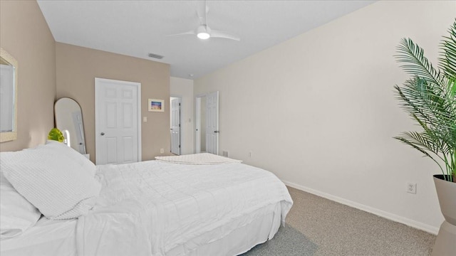 carpeted bedroom with visible vents, baseboards, and ceiling fan