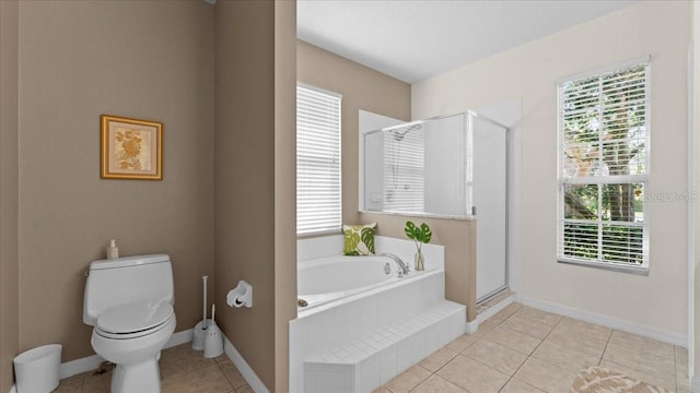 full bathroom with toilet, a healthy amount of sunlight, a stall shower, and a bath