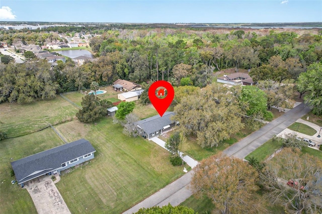 drone / aerial view with a residential view and a wooded view