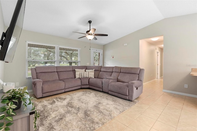 living room with tile patterned flooring, vaulted ceiling, baseboards, and ceiling fan