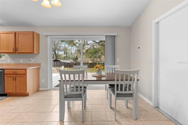 dining space with light tile patterned flooring and baseboards