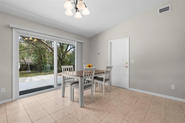 dining space with lofted ceiling, light tile patterned floors, and visible vents