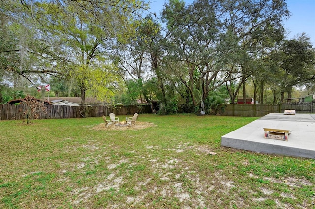 view of yard featuring an outdoor fire pit and a fenced backyard