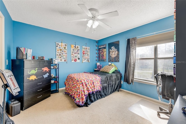 carpeted bedroom featuring ceiling fan, baseboards, and a textured ceiling