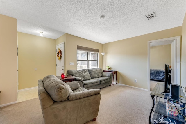 carpeted living room with baseboards, visible vents, and a textured ceiling