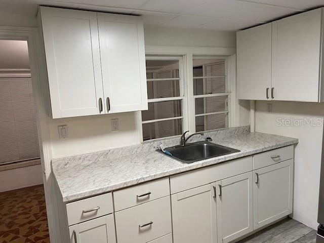 kitchen with a sink and white cabinets