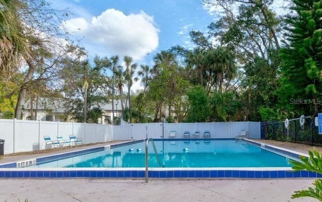 community pool featuring fence