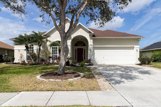 ranch-style home with driveway, a garage, a front lawn, and stucco siding