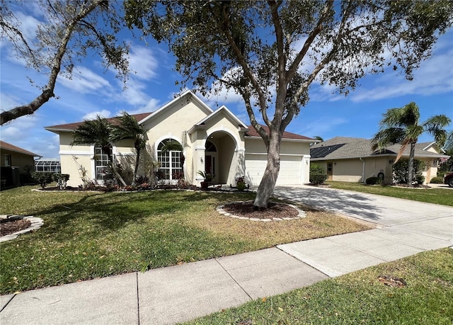 ranch-style home featuring a garage, a front lawn, concrete driveway, and stucco siding