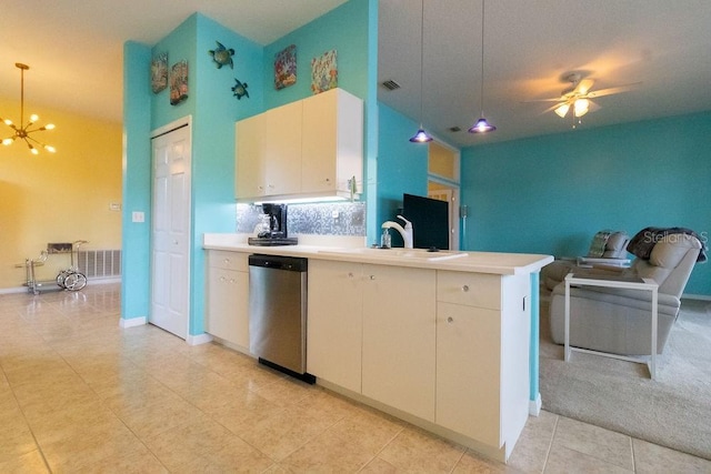 kitchen with decorative light fixtures, stainless steel dishwasher, open floor plan, a sink, and a peninsula