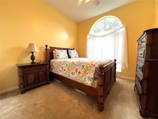 bedroom featuring lofted ceiling, ceiling fan, light carpet, and baseboards