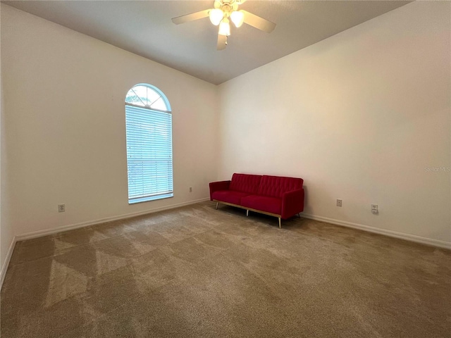 unfurnished room featuring carpet floors, ceiling fan, baseboards, and lofted ceiling