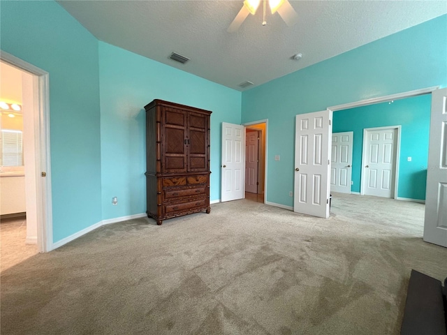 unfurnished bedroom featuring baseboards, visible vents, a textured ceiling, and carpet flooring