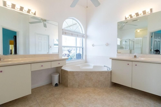 full bathroom with a garden tub, two vanities, a stall shower, ceiling fan, and tile patterned floors