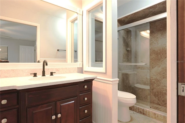 full bath with a stall shower, vanity, toilet, and tile patterned floors