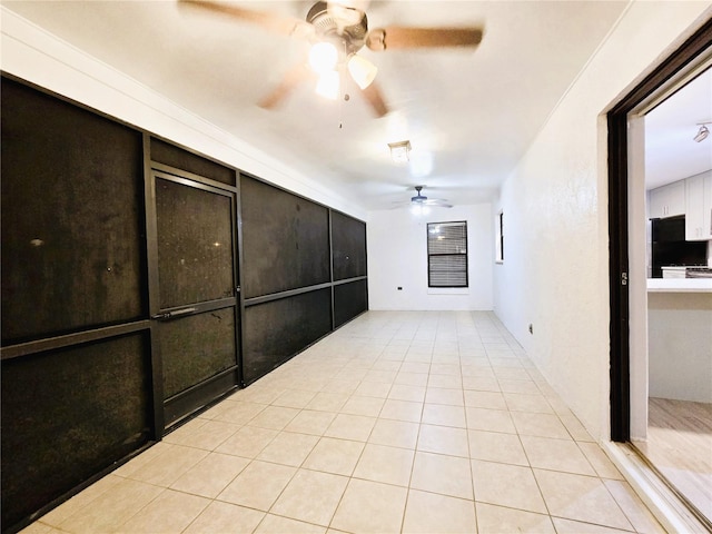 spare room featuring a ceiling fan and light tile patterned flooring