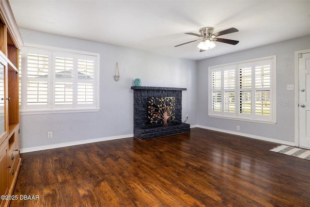 unfurnished living room featuring a fireplace, wood finished floors, and a healthy amount of sunlight