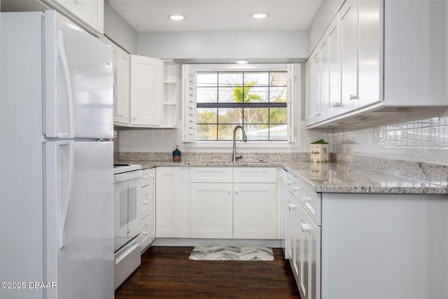 kitchen featuring white appliances, a sink, light stone countertops, white cabinetry, and backsplash