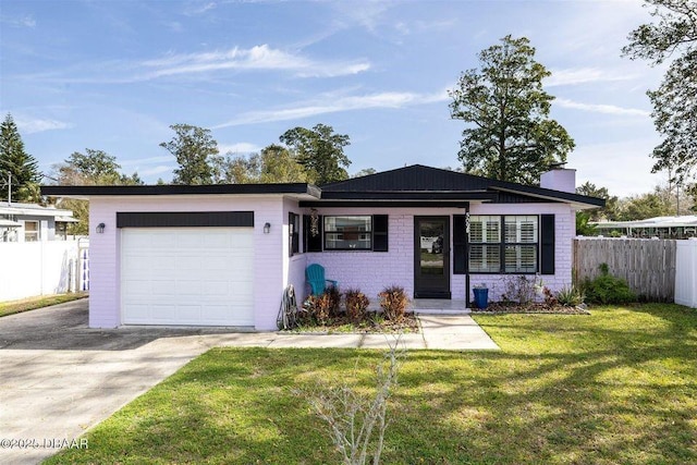 ranch-style house with an attached garage, brick siding, fence, concrete driveway, and a front yard