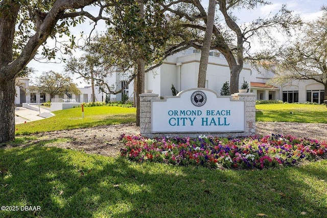 community sign featuring a lawn