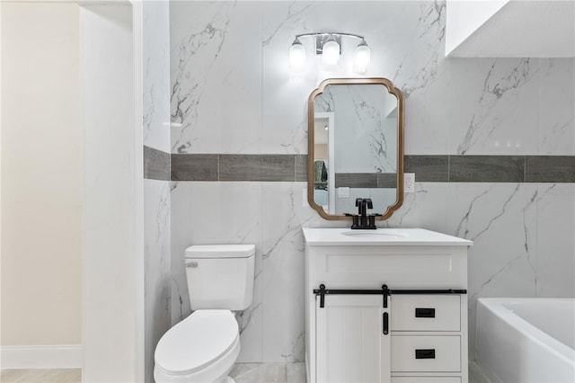 bathroom with toilet, a bath, and vanity