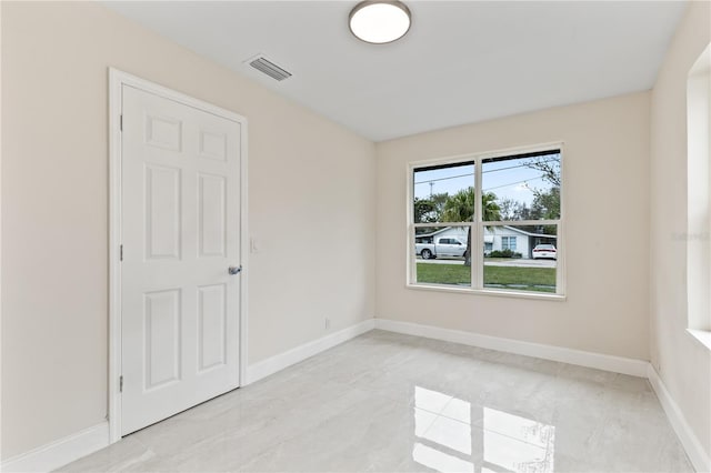 empty room with visible vents and baseboards