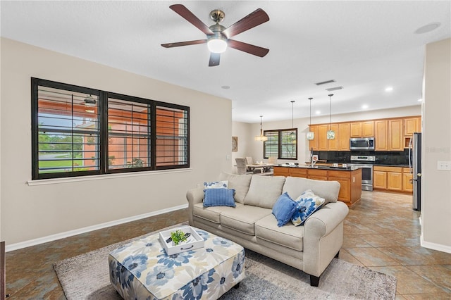 living room with recessed lighting, visible vents, baseboards, and a ceiling fan