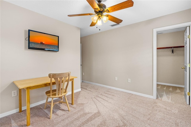 office space with a ceiling fan, carpet, visible vents, and baseboards