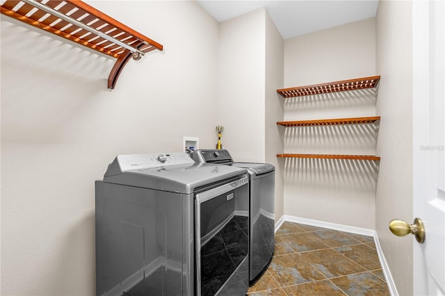 laundry area with washer and dryer, laundry area, and baseboards