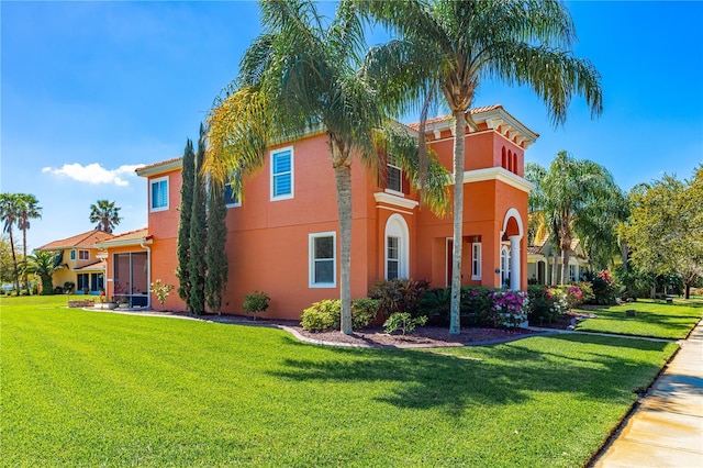 view of front of property with stucco siding and a front lawn