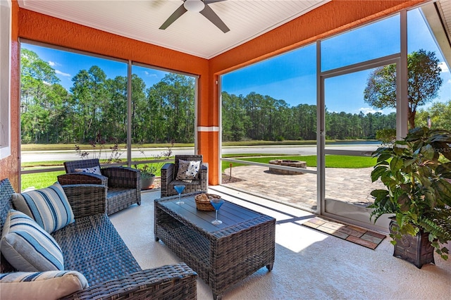 sunroom / solarium featuring plenty of natural light and ceiling fan