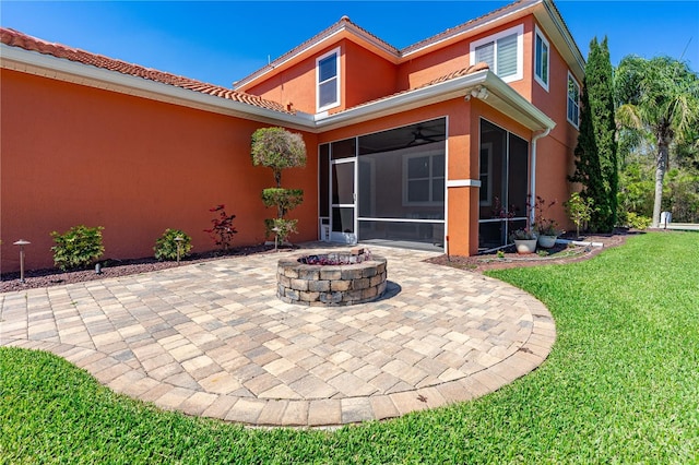 exterior space with an outdoor fire pit and a sunroom