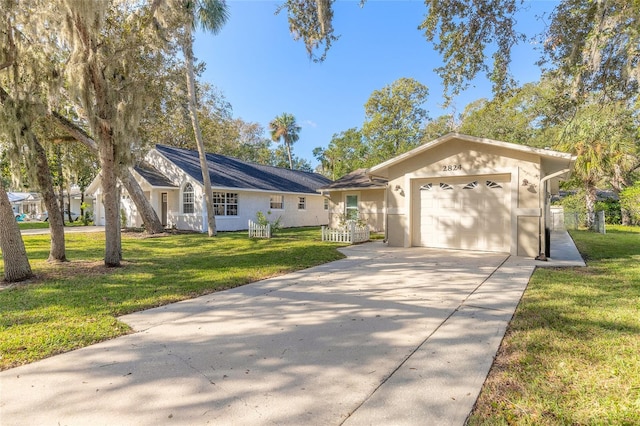 ranch-style home featuring a garage, a front lawn, concrete driveway, and stucco siding