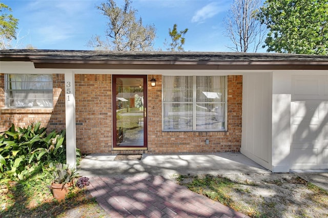 property entrance with brick siding