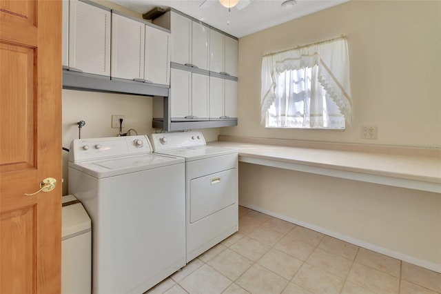 laundry room featuring light tile patterned floors, washing machine and clothes dryer, and cabinet space