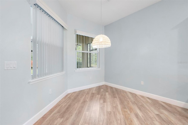 empty room with wood finished floors and baseboards